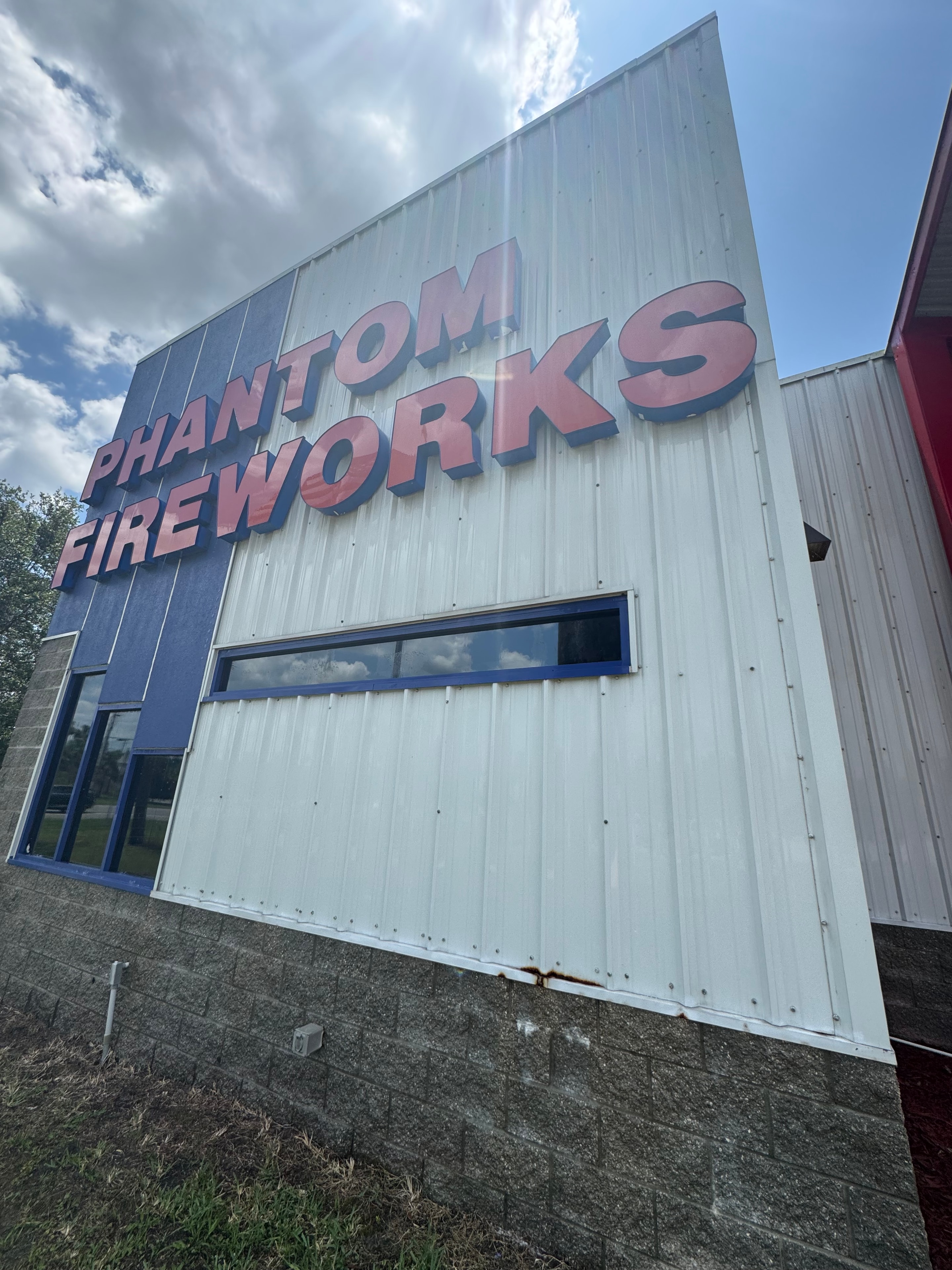 Phantom Fireworks commercial building exterior after pressure washing — bright white clean metal panel siding, Nocatee, Jacksonville, FL