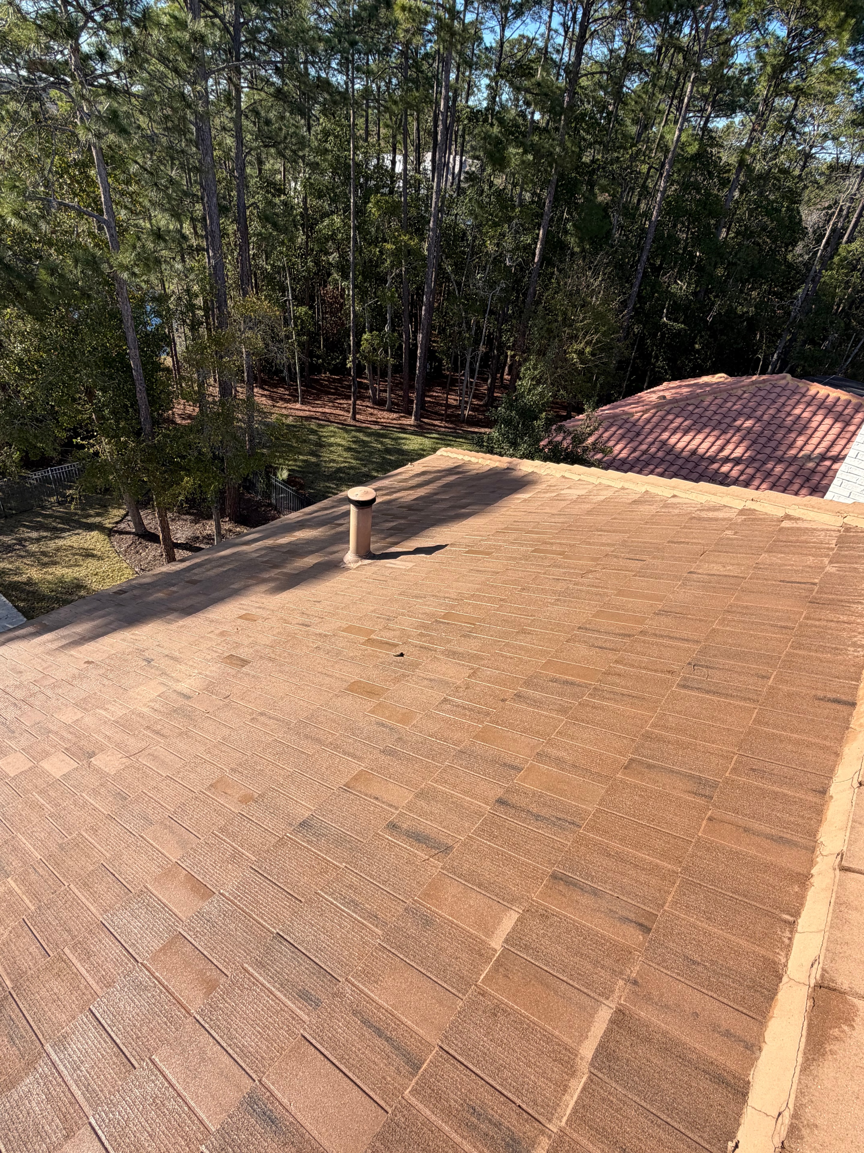Large brick retaining wall exterior cleaned by Seal Deal Pressure Washing, Jacksonville, FL