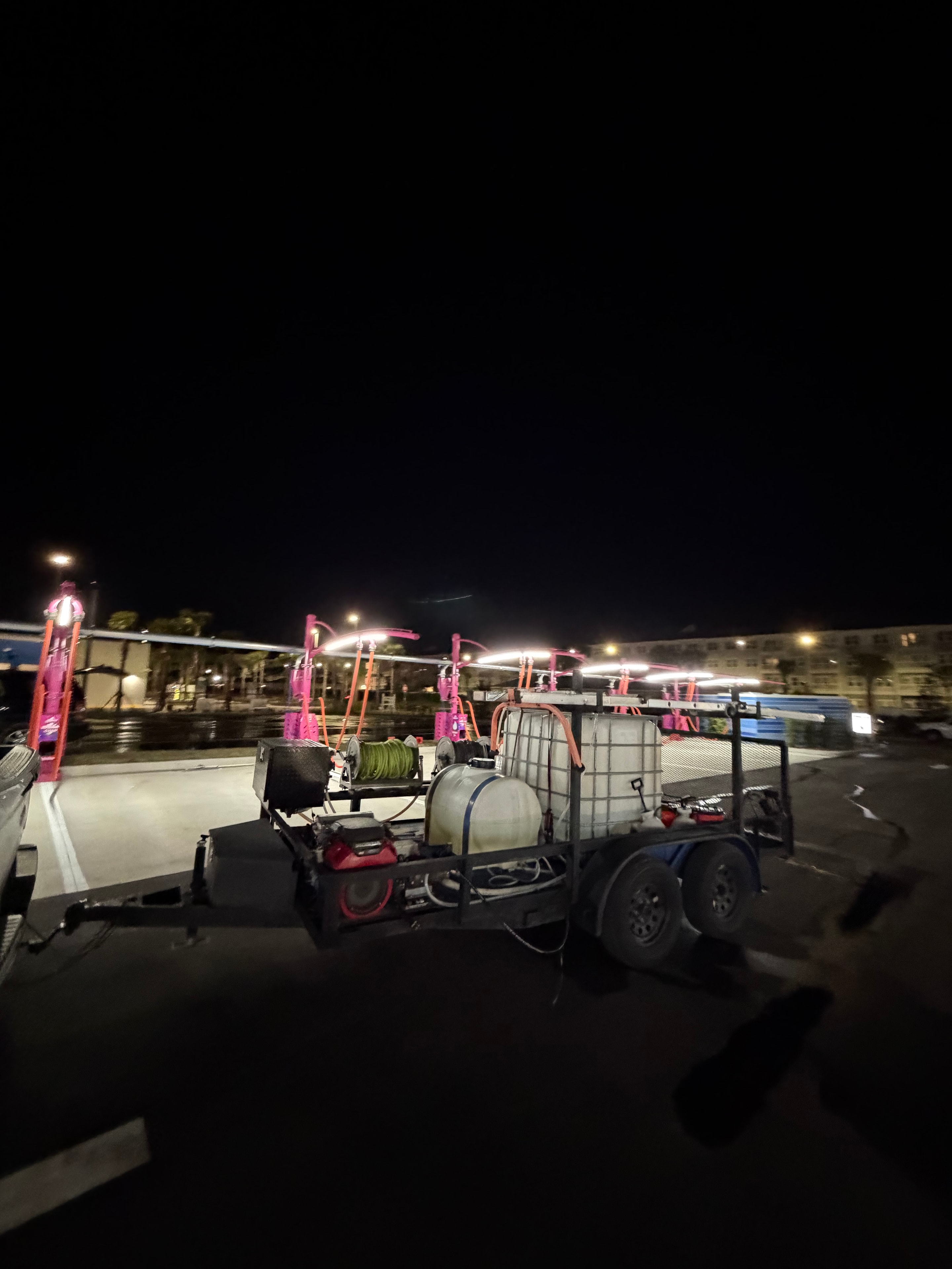 Seal Deal Pressure Washing trailer with hose reels and IBC tank at commercial property after hours, Jacksonville, FL